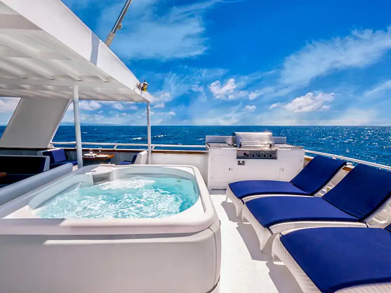A hot tub bubbles on a luxury yacht.
