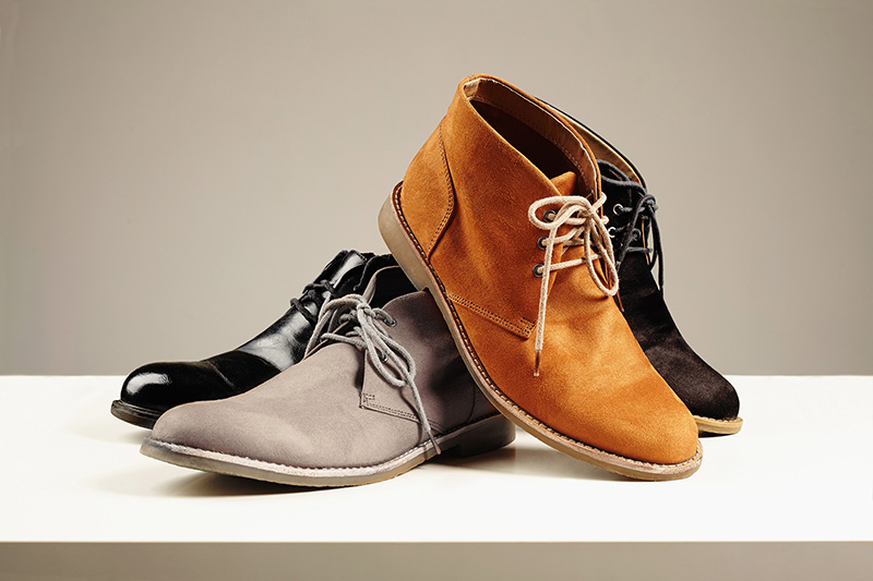A stack of dress and casual shoes in polished and suede varieties..