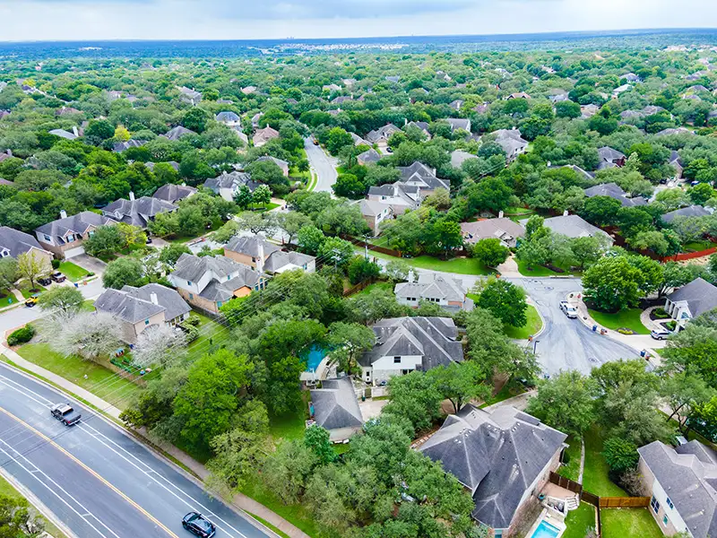 An overhead view of a modern housing development in a coastal area.