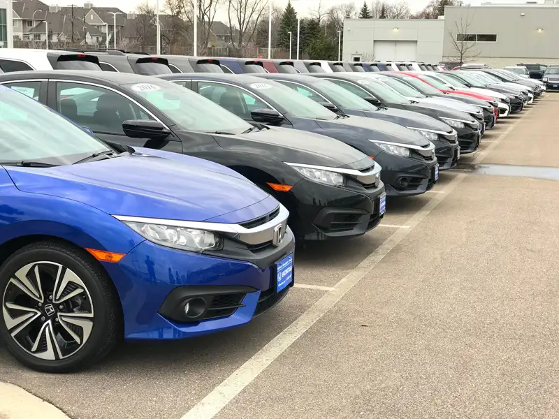A line of fleet vehicles in a lot.