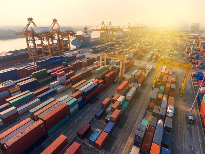 Sunrise on a dock where hundreds of shipping containers are staged.