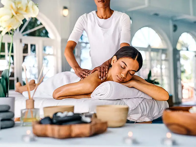 A health spa patron receives a soothing back massage.