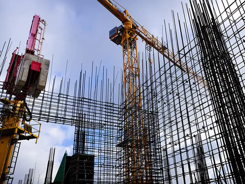 A large construction site where a rebar structure is in place awaiting the addition of concrete.