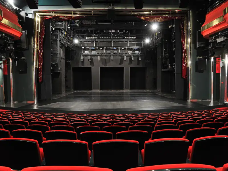 An beautiful red-themed, but empty theatre awaits a grand new production.