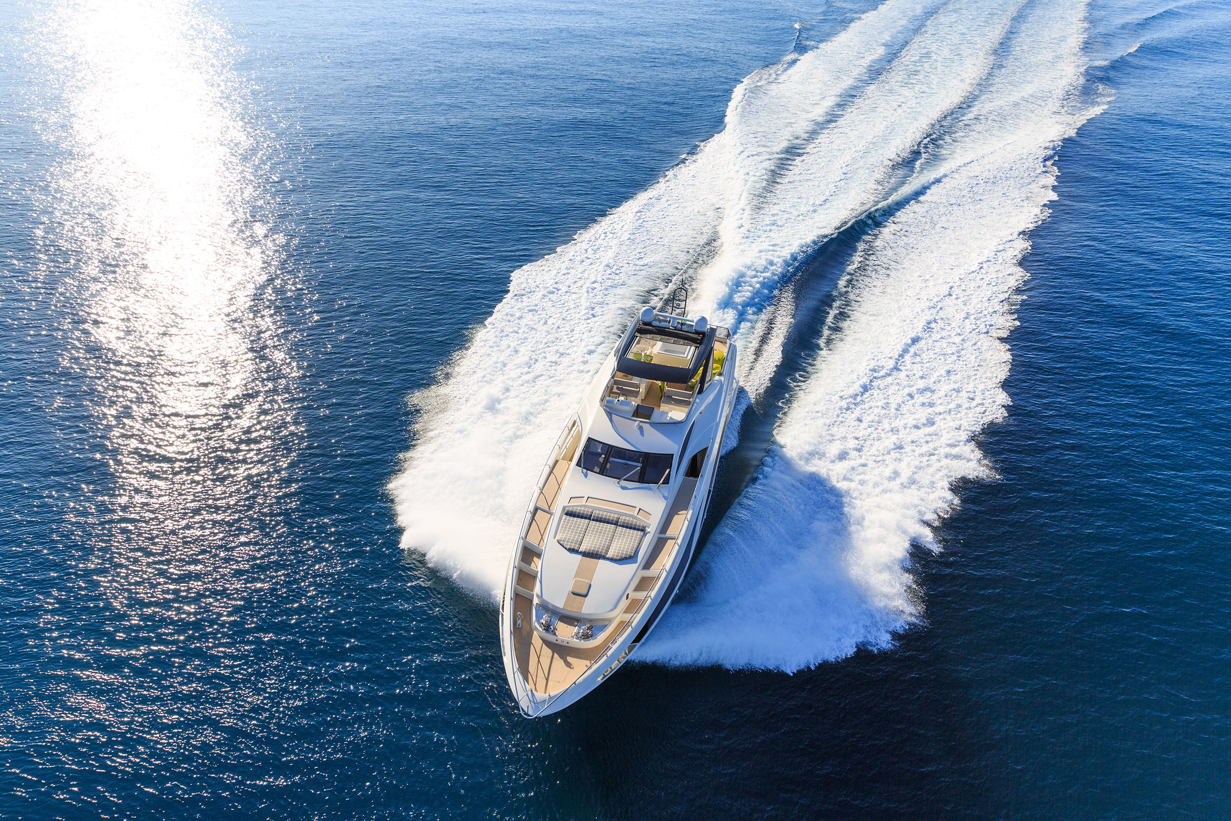 Overhead view of a yacht speeding along the water.