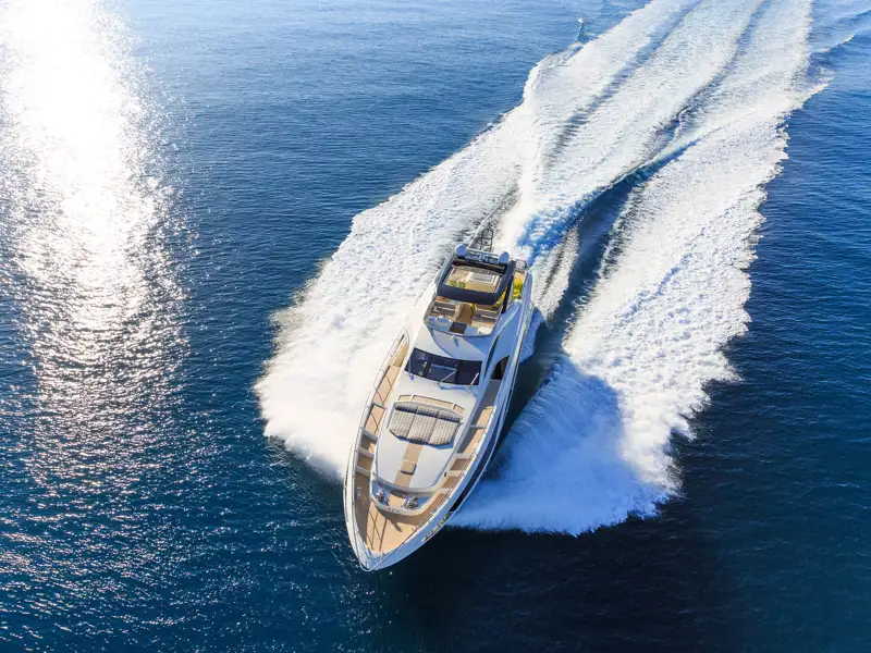 Overhead view of a yacht speeding along the water.