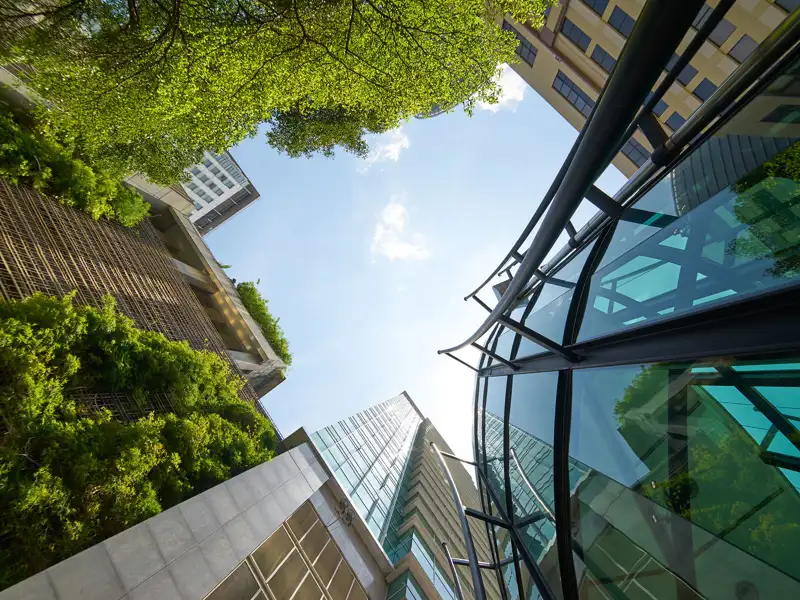 An upward view through the gap between tall buildings.