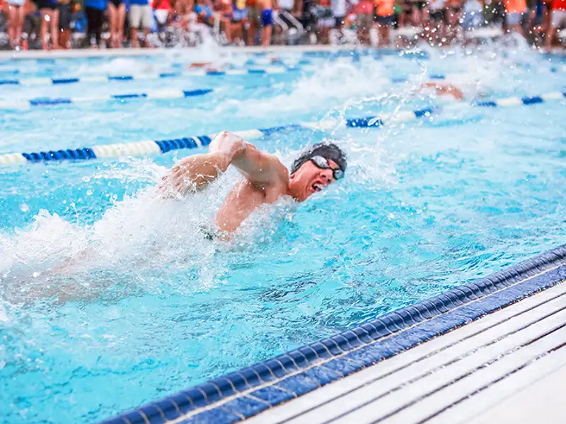 A competitive swimmer makes a charge while executing the Australian crawl.