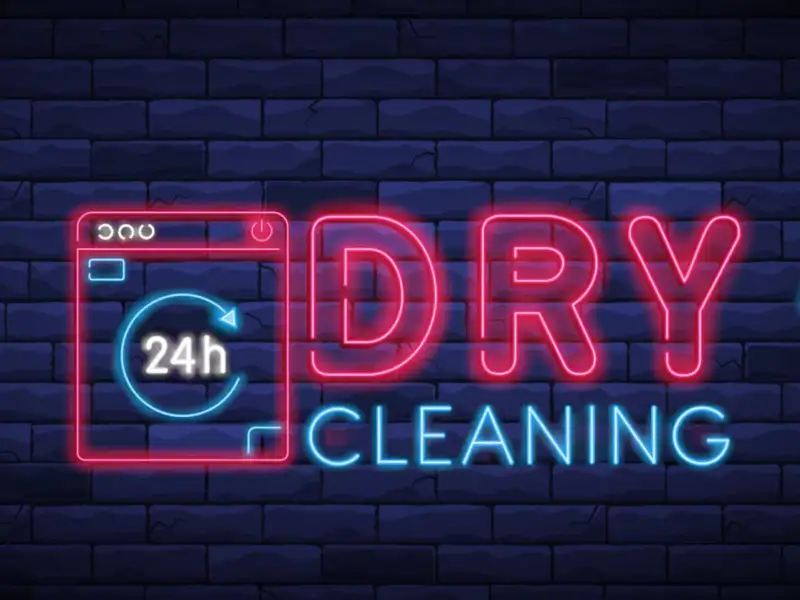 Neon sign promoting dry cleaning and laundry service.