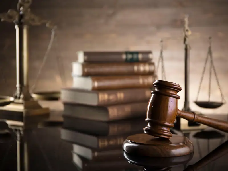 A desk with a gavel and legal literature.