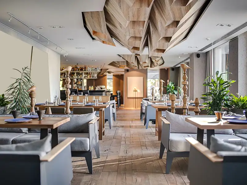 Restaurant in a modern style with textured walls and a parquet.