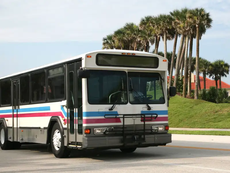 Public transit bus driving down the road.
